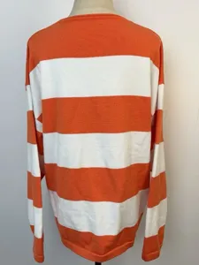 Detailed back view of a casual loose orange and white striped knit crewneck sweater