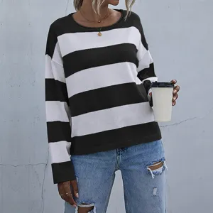Close-up of women's casual loose knit sweater with black and white horizontal stripes.
