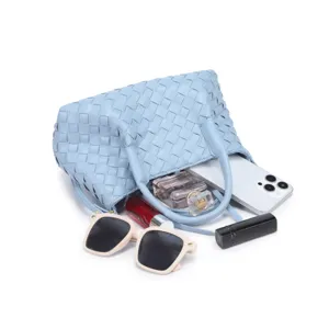 Woven leather tote handbag detail view, stylish blue fashion large capacity bag for women.