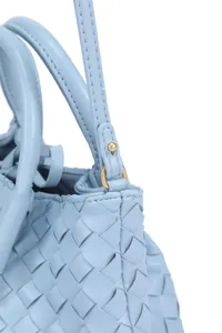 Close-up detail of light blue woven leather handbag strap and texture craftsmanship showcase.