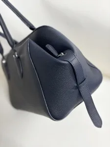Minimalist genuine leather bowling bag detail, premium cowhide tote shoulder bag for women daily.