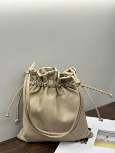 Beige leather bucket bag for women, stylish drawstring handbag with large capacity and soft design.