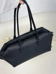 Close-up detail of the black genuine leather EW bowling shoulder bag showing fine texture.