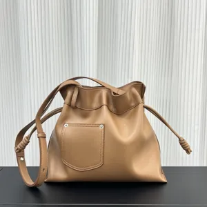 Vista detallada del bolso saco de cuero suave marrón con cordón ajustable y nudo elegante.