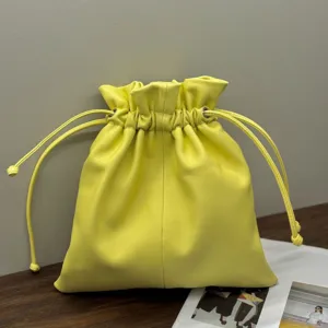 Yellow genuine leather drawstring bucket bag, minimalist cloud pouch for women, daily fashion design.