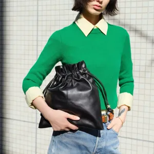 Black leather drawstring pouch bag for women, minimalist casual fashion bucket handbag.