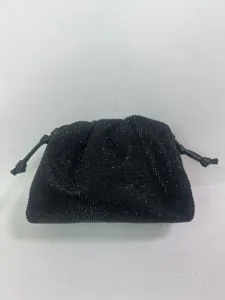 Detailed view of the black rhinestone pleated evening pouch, showcasing crystal surface and knots.