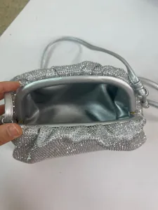Detailed view of the silver rhinestone pleated cloud bag interior, showing quality texture.