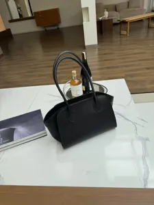 Minimalist black leather tote bag for women, spacious shoulder bag for daily office commuting.