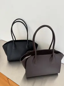 Minimalist leather tote bag, detailed view of the simple commuter handbag showcasing spacious design.
