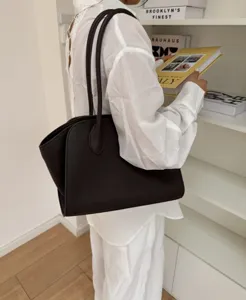 Minimalist cowhide leather tote bag for women, large capacity daily commuting shoulder handbag.