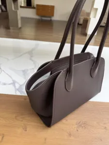 Elegant dark brown leather tote bag for women, minimalist large capacity shoulder handbag.