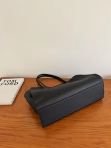 Black leather tote bag for women, minimalist large capacity shoulder handbag for daily work commute.