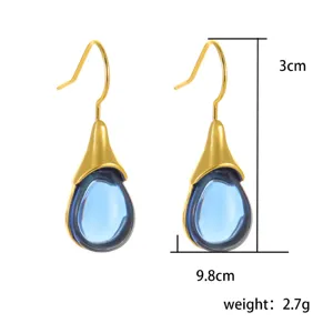 Gold-plated teardrop earrings with blue crystal stone insert, stylish and elegant jewelry accessory.