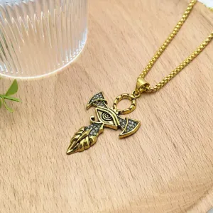 Detailed shot of retro gold eye ankh pendant necklace with delicate rhinestones and chain.