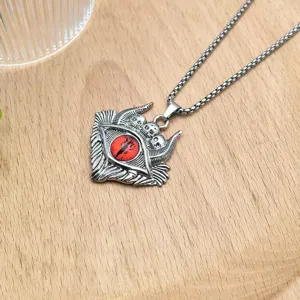 Gothic devil eye pendant necklace with red gemstone and metal chain, unique vintage jewelry.