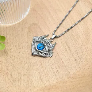 Gothic demon eye pendant necklace detailed shot, punk skull silver metal chain jewelry accessory.