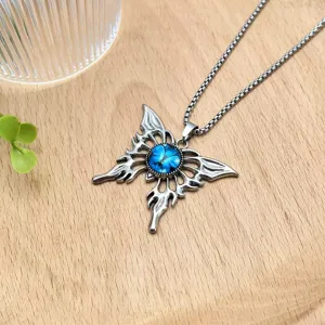 Detail closeup of gothic demon butterfly pendant necklace with blue stone and silver wings.