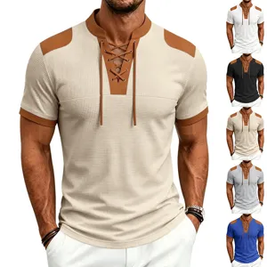 Close-up view of the waffle knit short sleeve fabric, contrast patches, and lace-up V-neck detail.