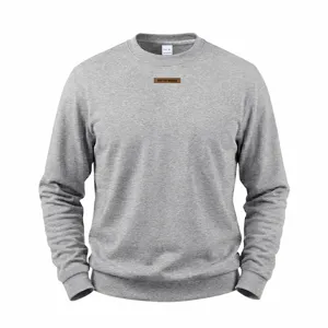 Detailed view of grey fleece-lined crewneck sweatshirt with chest patch and soft fabric.