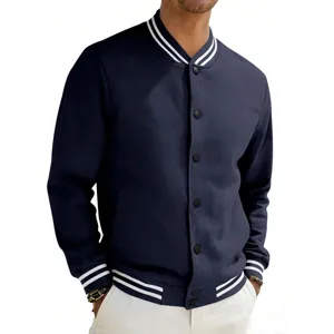 Close-up detail of dark blue varsity jacket with white striped ribbed collar and snaps.