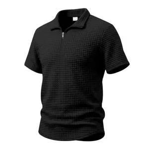 Detailed view of men's black waffle knit short sleeve polo shirt with half zipper collar.
