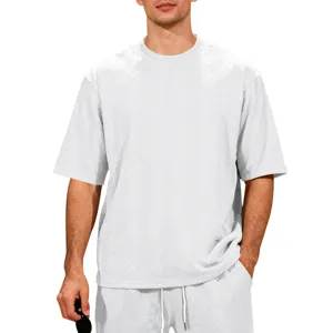 Detailed view of the textured knit fabric on the casual white oversized t-shirt.