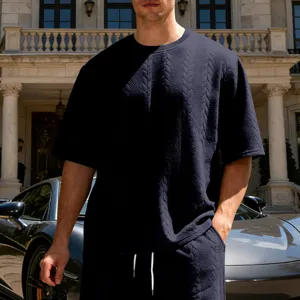 Textured cable knit short sleeve t-shirt detail showing premium fabric and relaxed fit.