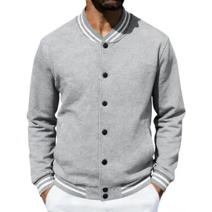 Close-up detail of the grey varsity baseball jacket with striped cuffs and black buttons.