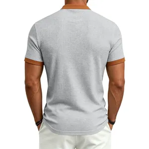 Men's waffle knit short sleeve polo shirt featuring contrast color collar and cuffs detail.