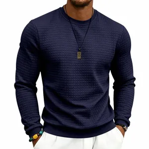 Close-up detail of men's dark blue waffle knit crewneck sweatshirt showing fabric texture.