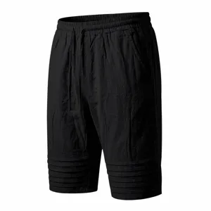 Close-up detail view of men's black casual drawstring shorts featuring pleated hem.