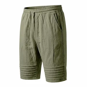 Men's casual olive green shorts with elastic drawstring waist and pleated cuff detailing for summer.