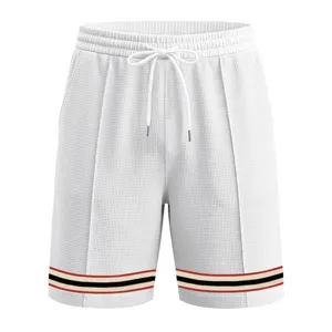 Men waffle knit casual sports shorts detail view featuring contrast stripe hem and drawstring.