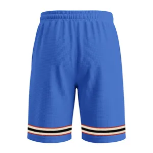 Close-up detail of blue waffle knit athletic shorts with contrast striped cuffs, casual wear.
