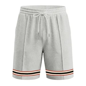 Grey waffle knit shorts detail featuring contrast striped hem ribbon and adjustable drawstring.