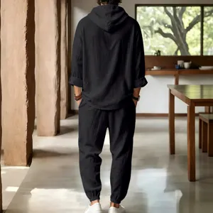 Men's casual linen short-sleeve hoodie and pants set lifestyle scene detail view in black.