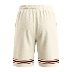 Detailed closeup view of mens casual waffle knit shorts texture and elastic striped hem design.