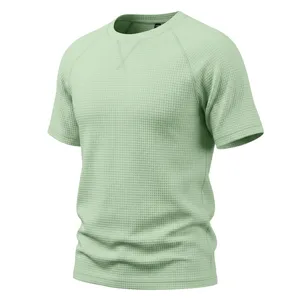 Close-up of men's breathable waffle knit short sleeve t-shirt texture and crew neck detail.