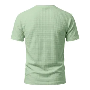 Back detail of light green waffle knit short sleeve t-shirt, breathable casual texture.