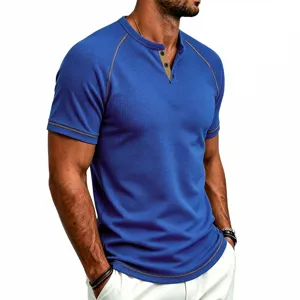 Close-up detail of men's blue waffle knit short sleeve henley t-shirt with contrast buttons.