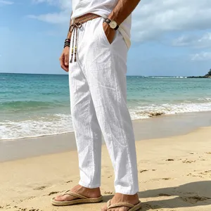 Detail view of men's casual white linen pants in a breathable beach vacation style.