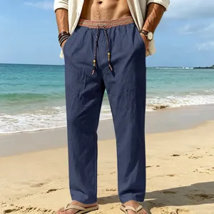 Casual beach linen trousers detail shot, showing ethnic style drawstring waist and relaxed fit.