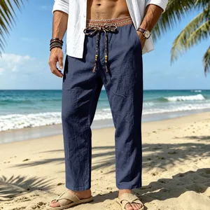 Detailed view of men's casual beach linen trousers with ethnic contrast waistband and drawstring.