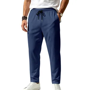 Detail shot of men's blue casual trousers featuring elastic drawstring waist and pockets.