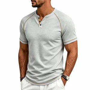 Detail view of men waffle knit short sleeve henley shirt with contrast raglan seams and buttons.