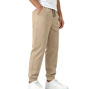 Detailed view of men's casual khaki jogger pants with elastic cuffs and adjustable drawstring.