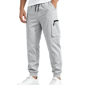 Detail view of mens grey cargo sweatpants featuring side zipper pocket and elastic cuffed hem.