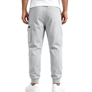 Men casual grey sweatpants detail view, featuring elastic cuffs and side cargo pockets.