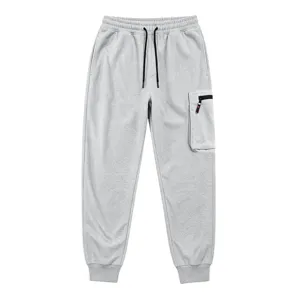 Detail view of light grey cargo sweatpants, featuring secure zipper pocket and cuffed ankles.